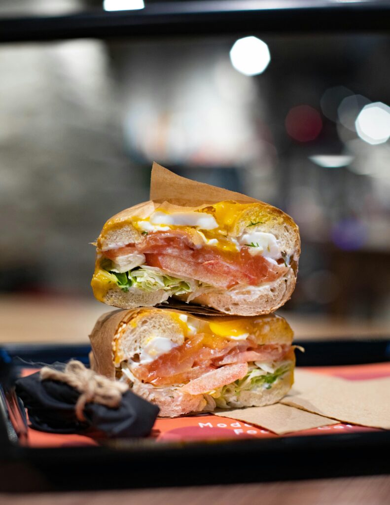 Appetizing stacked sandwich with vegetables and cheese on a table indoors.